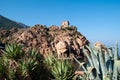 A rock with an old defensive stone tower above sea level in the city of Porto on the island of Corsica in France. Royalty Free Stock Photo