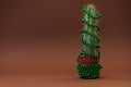 Cactus as Christmas tree with green ball garland on browm background. Christmas and New Year holidays celebration concept. Front Royalty Free Stock Photo