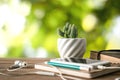 cactus flower notebook, pencil and smartphone on wood table with Royalty Free Stock Photo