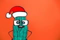 Cactus hipster man with santa hat. Tropical Christmas concept. Minimal fun art Royalty Free Stock Photo