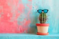 A cactus wearing sunglasses and pink glasses. The cactus is in a blue pot. The image has a fun and playful mood. Banner in a pink Royalty Free Stock Photo