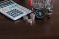 Caculator , Stack of coins , shopping trolley and compass with copay space Royalty Free Stock Photo