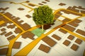 Cadastral map with a tree on a green area - concept image