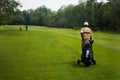 Caddie carrying golferÃ¢â¬â¢s club Royalty Free Stock Photo