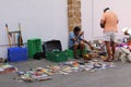 An unknown person sells his second hand books in Cadiz, Spain