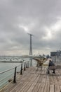 Landscape with a man fishing in the bay of Cadiz with a huge communications tower in the background Royalty Free Stock Photo