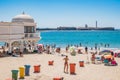 Cadiz SPAIN - 8 August 2022 - La Caleta beach with bathers in front of San Sebastian castle and with spa structure on the sand