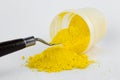 Cadmium Yellow pigment on a white background