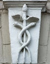 Caduceus as a symbol of medicine. A simplified image of the Caduceus on the facade of a building