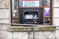Caernarfon , Wales - May 01 2018 : Cash machine of the HSBC Bank on a windy day in the rain