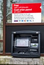 Caernarfon , Wales - May 01 2018 : Cash machine of the HSBC Bank on a windy day in the rain