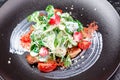 Caesar`s creative feed. Traditional salad with grilled chicken, tomatoes, cheese, spinach and cream sauce