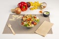 Caesar salad with assorted lettuce sprouts, split cherry tomatoes, parmesan cheese flakes and mayonnaise sauce on white background