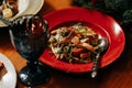 Caesar salad in a beautiful plate on a served table of a restaurant is decorated with microgreens