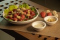 Caesar salad in the big white dish with strawberry and fresh vegetable on wood table for dinner Royalty Free Stock Photo