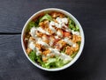 Caesar salad on black wooden table Royalty Free Stock Photo