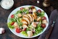 Caesar salad with chicken breast, croutons and parmesan sauce on a wooden Royalty Free Stock Photo