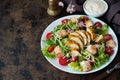 Caesar salad with chicken breast, croutons and parmesan sauce on a wooden table Royalty Free Stock Photo