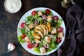 Caesar salad with chicken breast, croutons and parmesan sauce on a wooden table Royalty Free Stock Photo