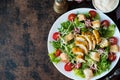 Caesar salad with chicken breast, croutons and parmesan sauce on a wooden table, a copy of space Royalty Free Stock Photo