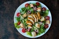 Caesar salad with chicken breast, croutons and parmesan sauce on a wooden table Royalty Free Stock Photo