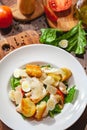 Caesar salad with chicken breast, eggs, croutons, parmesan cheese on white plate. Top view Royalty Free Stock Photo