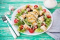 Caesar salad with chicken breast on a rustic background, tomatoes, parmesan, green salad and croutons Royalty Free Stock Photo