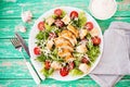 Caesar salad with chicken breast on a rustic background, tomatoes, parmesan, green salad and croutons, selective focus Royalty Free Stock Photo