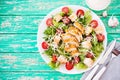 Caesar salad with chicken breast on a rustic background, tomatoes, parmesan, green salad and croutons, selective focus, top view Royalty Free Stock Photo