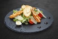 Caesar salad with chicken on a dark stone board Royalty Free Stock Photo