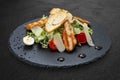 Caesar salad with chicken on a dark stone board Royalty Free Stock Photo