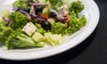 Caesar salad with chicken fillet and parmesan cheese, onion, olives, salad. Royalty Free Stock Photo