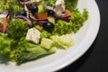 Caesar salad with chicken fillet and parmesan cheese, onion, olives, salad. Royalty Free Stock Photo