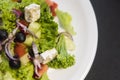 Caesar salad with chicken fillet and parmesan cheese, onion, olives, salad. Royalty Free Stock Photo