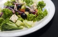 Caesar salad with chicken fillet and parmesan cheese, onion, olives, salad. Royalty Free Stock Photo