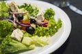 Caesar salad with chicken fillet and parmesan cheese, onion, olives, salad. Royalty Free Stock Photo