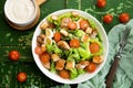 Caesar salad with chicken fillet, tomatoes, croutons and parmesan in a plate on a rustic wooden background Royalty Free Stock Photo