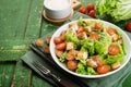 Caesar salad with chicken fillet, tomatoes, croutons and parmesan in a plate on a rustic wooden background Royalty Free Stock Photo