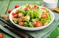 Caesar salad with chicken fillet, tomatoes, croutons and parmesan in a plate on a rustic wooden background Royalty Free Stock Photo