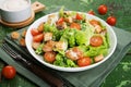 Caesar salad with chicken fillet, tomatoes, croutons and parmesan in a plate on a rustic wooden background Royalty Free Stock Photo