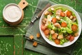 Caesar salad with chicken fillet, tomatoes, croutons and parmesan in a plate on a rustic wooden background Royalty Free Stock Photo