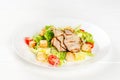 Caesar salad with chicken and fresh herbs in a white plate Royalty Free Stock Photo