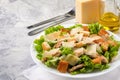 Caesar salad with chicken and herbs on the table, Caesar sauce, Parmesan cheese