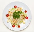 Caesar salad with chicken on a white plate and on a white background, top view Royalty Free Stock Photo