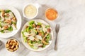 Caesar salad with the classic sauce and wine, shot from above on a white marble background Royalty Free Stock Photo