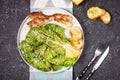 Caesar salad with crispy bread and bacon close up on black stone background Royalty Free Stock Photo