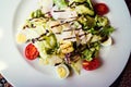 Caesar salad with croutons, parmesan, quail eggs, cherry tomatoes and grilled chicken Royalty Free Stock Photo