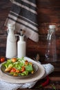 Caesar salad with croutons, quail eggs, cherry tomatoes and grilled chicken in white plate on dark rustic table Royalty Free Stock Photo