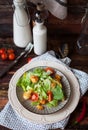 Caesar salad with croutons, quail eggs, cherry tomatoes and grilled chicken in white plate on dark rustic table Royalty Free Stock Photo