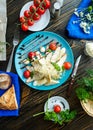 Caesar salad with croutons, quail eggs, cherry tomatoes and grilled chicken in wooden plate on dark rustic table Royalty Free Stock Photo